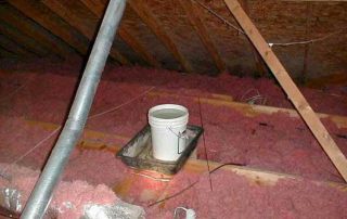 bucket collecting water from a roof leak